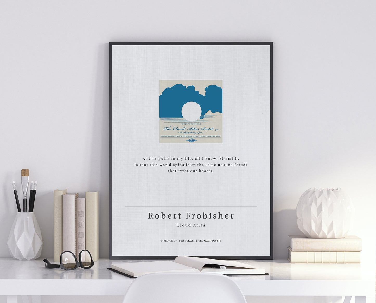 Cloud Atlas movie quote digital poster featuring Robert Frobisher’s quote "At this point in my life, all I know, Sixsmith, is that this world spins from the same unseen forces that twist our hearts." on an off-white background with an art design of the Cloud Atlas Sextet vinyl record album.