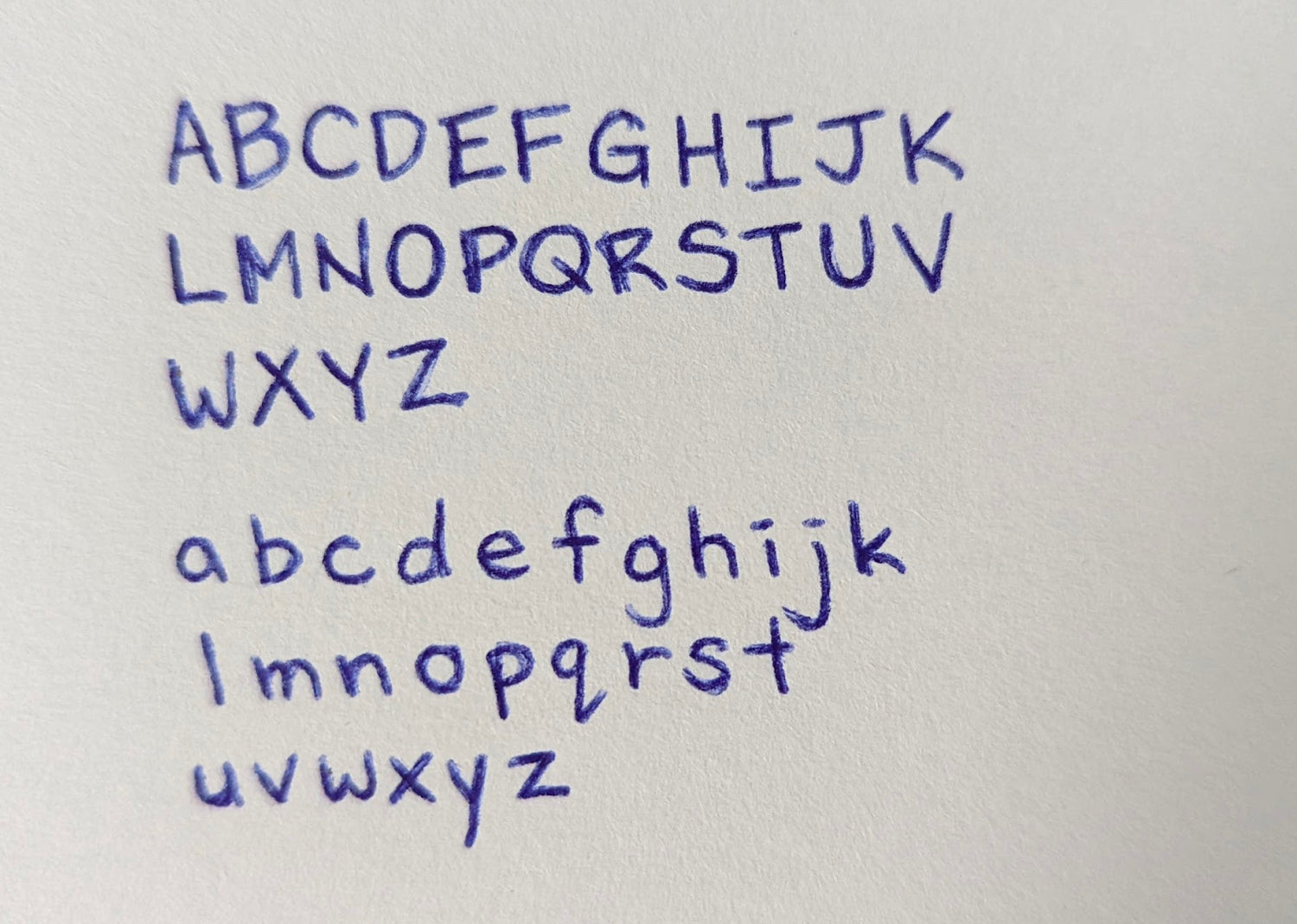 Image of handwritten alphabet letters in blue pen