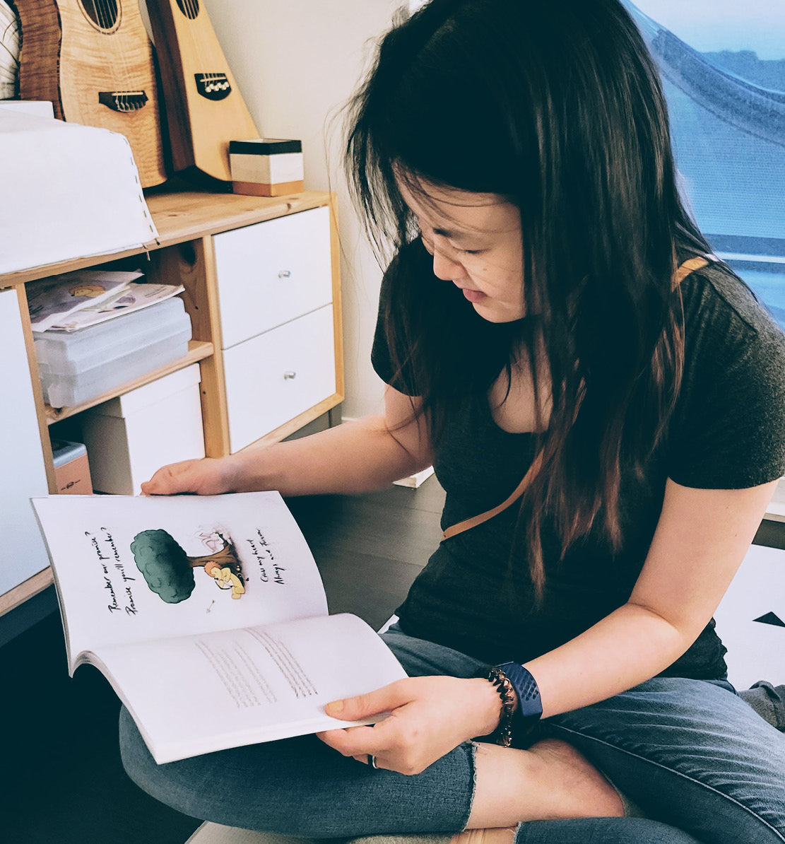 Image of a woman reading a children's book